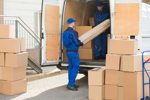 Removal team handling household items in a Millbank residential move