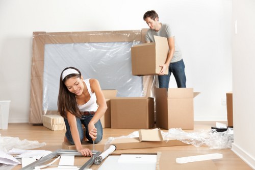 Furniture collection team handling bulky items in a Millbank residential property