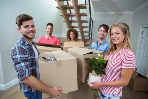 Man and van removals service in Millbank with moving van near riverside buildings