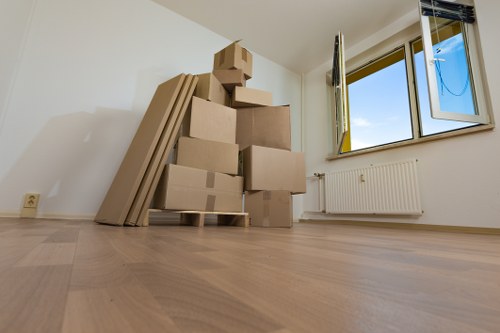 Local moving team loading furniture and boxes into a van in Millbank